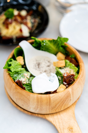 caesar salad on wood bowl - healthy food styleの写真素材