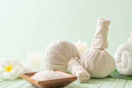 Spa herbal compressing ball with candle and orchid - beauty conceptの写真素材