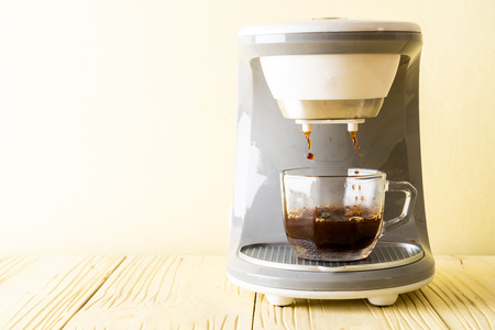 coffee maker machine making coffee on wood backgroundの写真素材