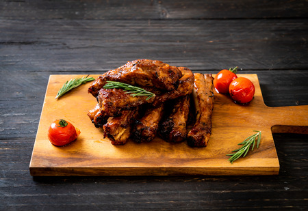 grilled barbecue ribs pork with rosemary and tomatoesの写真素材