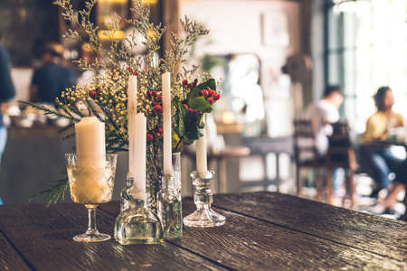 candle and vase decoration on table in cafe restaurant - vintage effect filterの写真素材