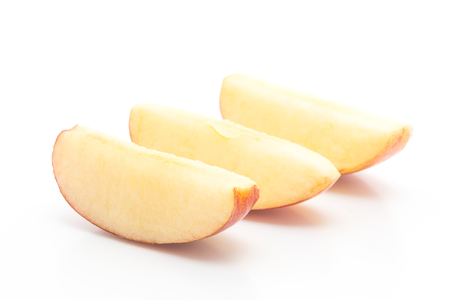 fresh red apples sliced isolated on white backgroundの写真素材