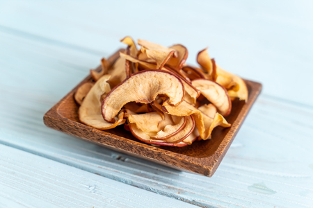 Homemade dried organic apple sliced on wood backgroundの写真素材