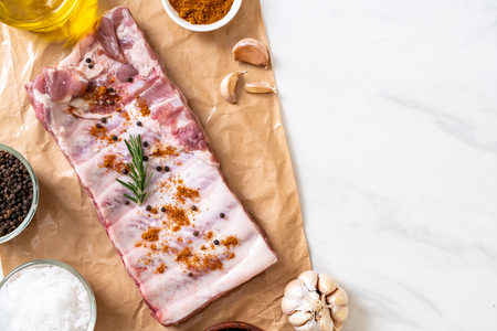 Fresh raw pork ribs ready for roasting with ingredientsの写真素材