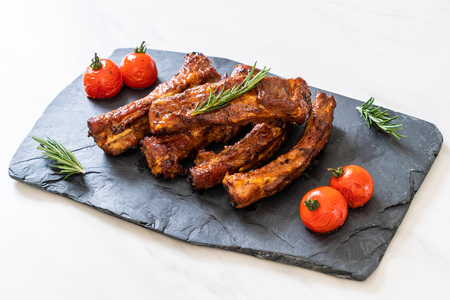 grilled barbecue ribs pork with rosemary and tomatoesの写真素材