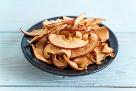 Homemade dried organic apple sliced on wood backgroundの写真素材