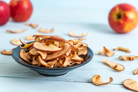 Homemade dried organic apple sliced on wood background