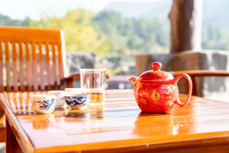 tea pot and cup in chinese style on the table with morning sunlightの写真素材