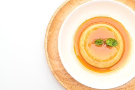 homemade caramel custard pudding isolated on white backgroundの写真素材