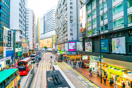 HONG KONG - FEB 21 2019: People walking across Hennessy Road, Causeway Bay with a big department store in Hong Kong.のeditorial素材