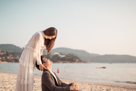 Happy Asian couple going honeymoon travel on tropical sand beach in summerの写真素材