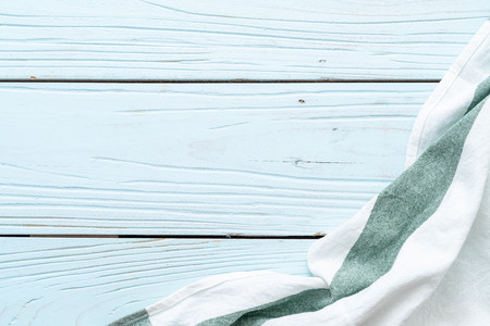 kitchen cloth (napkin) on blue wooden background with copy space