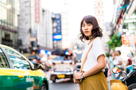 Happy Young Asian Woman Traveler with view at China Town in Bangkok, Thailandの写真素材