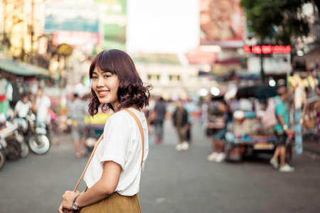 Happy and Beautiful Asian woman traveling at Khao Sarn Road in Thailand