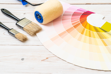 sample colors catalogue or colour swatches book with paint roller brushの写真素材