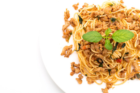 stir-fried spicy spaghetti with minced pork and basil isolated on white backgroundの写真素材