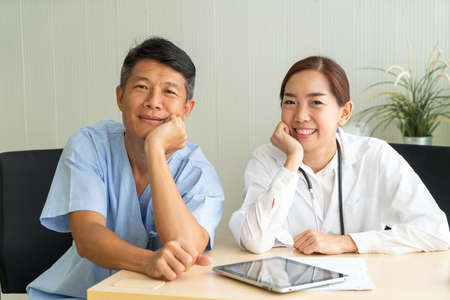 Asian Senior Patient Having Consultation With Doctor in Office  - selective focus pointの写真素材