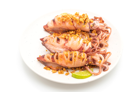 fried squid with garlic isolated on white backgroundの写真素材