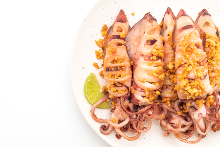 fried squid with garlic isolated on white backgroundの写真素材