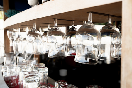 close-up hanging glasses on bar - selective focus pointの写真素材