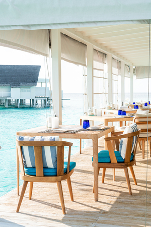 beautiful empty table and chair decoration in restaurantの写真素材