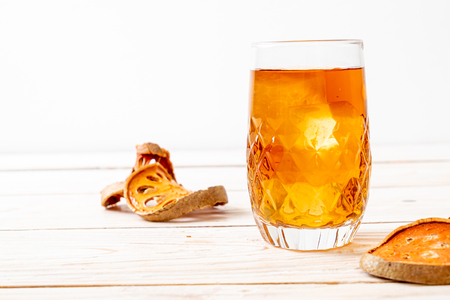 Bael Fruit Herbal Drink Glass on Wood Backgroundの写真素材