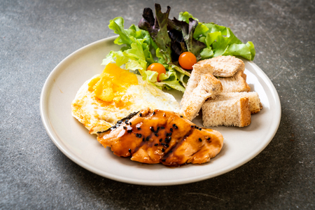 salmon teriyaki steak with fried egg and salad - healthy food styleの写真素材