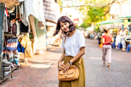 Happy and Beautiful Asian woman traveling at Khao Sarn Road in Thailand