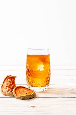 Bael Fruit Herbal Drink Glass on Wood Backgroundの写真素材