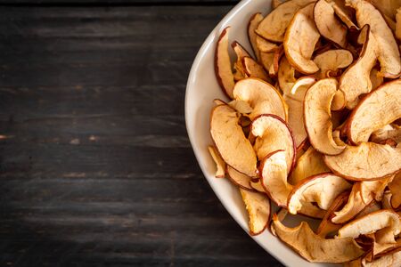 Homemade dried organic apple sliced on wood backgroundの写真素材