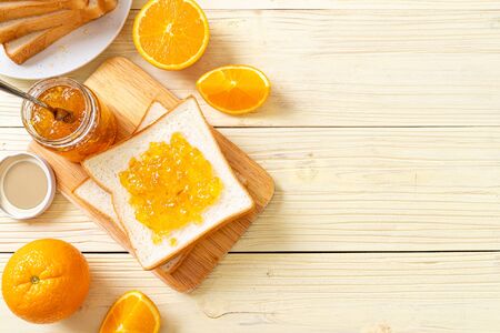 Slices of bread with orange jam for breakfastの写真素材