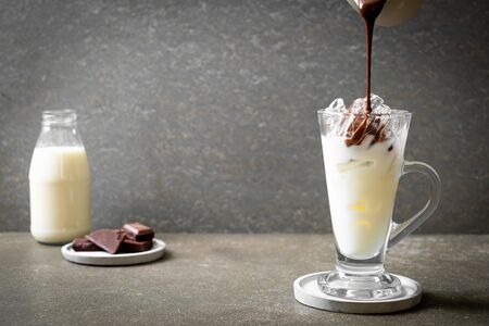 Iced chocolate milkshake drink on wood background