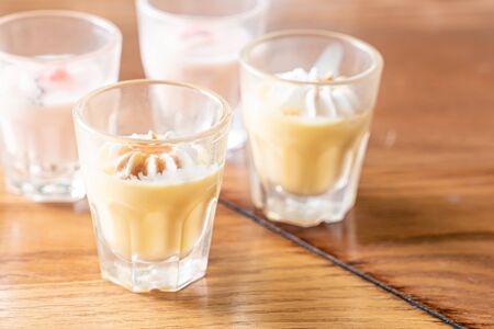 caramel custard glass with white creamの写真素材