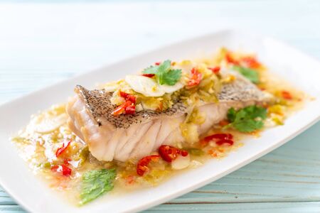 Steamed Grouper Fish Fillet with Chili Lime Sauce in lime dressing - Asian food styleの写真素材