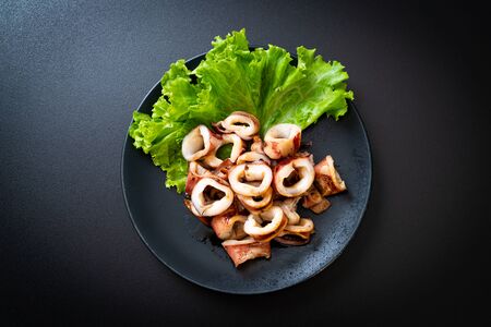 grilled squid on black plate