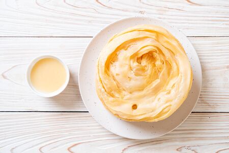 fried crispy roti dough with sweetened condensed milkの写真素材