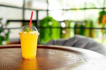 mango smoothies glass in cafe restaurantの写真素材