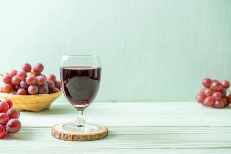 fresh grape juice on wood backgroundの写真素材