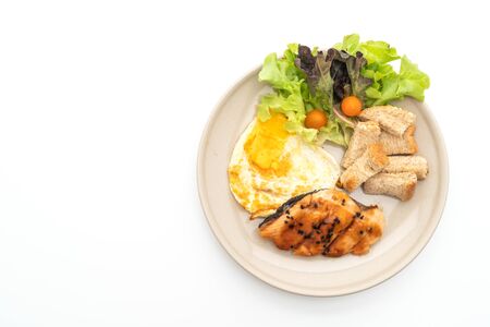 salmon teriyaki steak with fried egg and salad isolated on white backgroundの写真素材