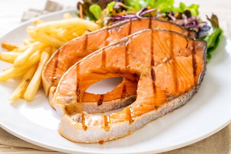 double grilled salmon steak fillet with french friesの写真素材