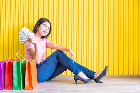 Asian women shopping addicted holding shopping bagsの写真素材