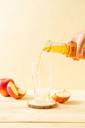 Apple juice with red apples fruit on wood backgroundの写真素材