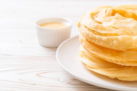 fried crispy roti dough with sweetened condensed milkの写真素材