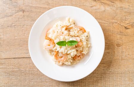 italian risotto with shrimps on white plateの写真素材