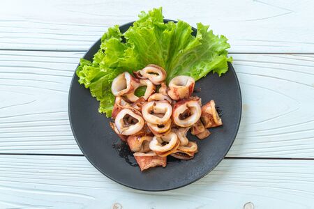 grilled squid on black plateの写真素材