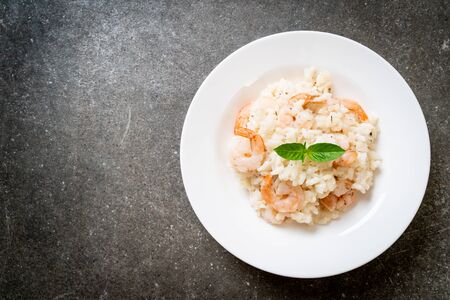 italian risotto with shrimps on white plateの写真素材