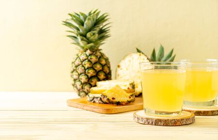 fresh pineapple juice on wood backgroundの写真素材
