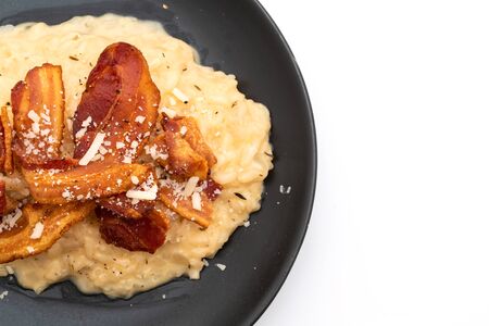risotto with crispy bacon isolated on white backgroundの写真素材