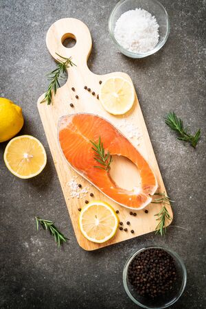 fresh raw salmon fillet steak with ingredient on boardの写真素材