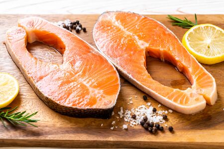 fresh raw salmon fillet steak with ingredient on boardの写真素材